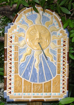 Mosaic tile sundial with sun face